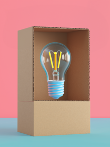 A cardboard box opening to reveal a lightbulb, symbolizing innovative packaging solutions that illuminate the product’s value