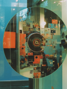 A mirror reflecting a film reel turning into pixels, symbolizing the transition from traditional cinema to digital content consumption