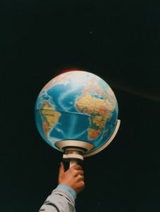 A spotlight shining on a globe, symbolizing the global reach of media and entertainment industries