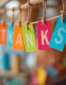 Colorful hanging tags spelling out the word THANKS, with each letter on a separate tag in a different bright color
