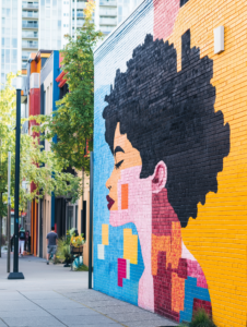 A colorful mural or street art that adds character to a neighborhood, illustrating the role of art in urban environments