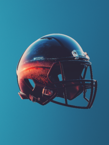 A football helmet with a reflection of a stadium in the visor, symbolizing the anticipation and focus in competitive sports