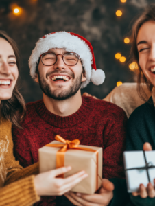 A group of friends laughing and exchanging Secret Santa gifts, representing the joy of giving and camaraderie