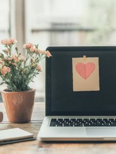 A laptop screen displaying a positive affirmation sticky note, showing how technology can integrate self-love practices into daily routines