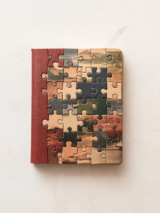 A passport made of jigsaw puzzle pieces, symbolizing how each travel destination fits together to form a unique travel experience