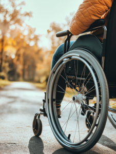 A person using assistive devices, like a speech-generating device or a smart wheelchair, showcasing how technology aids individuals with disabilities