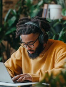 A student attending an online class, wearing headphones and taking notes, representing the shift to virtual learning environments