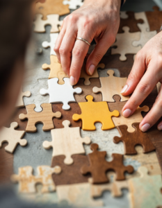 A person fitting together puzzle pieces, representing the process of analyzing information and finding solutions