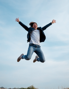 A person jumping for joy, their body language expressing excitement and celebration