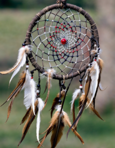 An intricate Native American dreamcatcher woven with feathers and beads