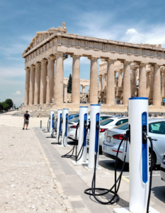 A row of electric car charging stations installed in front of the Parthenon