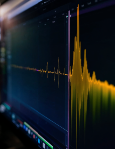 A sound wave being stretched, compressed, and manipulated on a computer screen, visualizing the process of audio editing